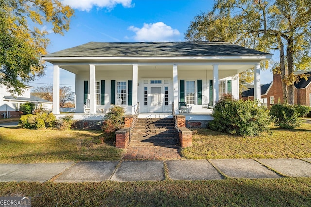 bungalow-style home with a front lawn and a porch