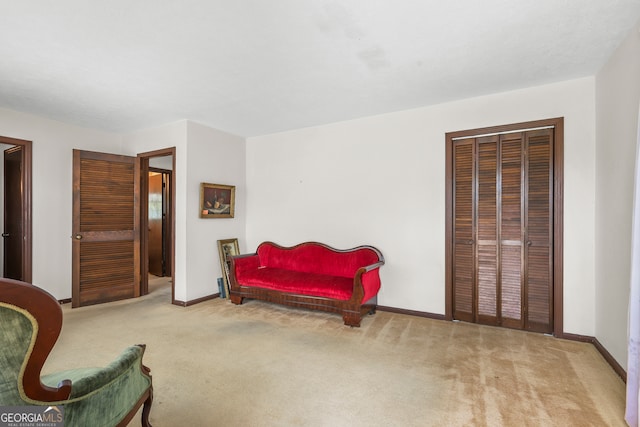 living area featuring light carpet