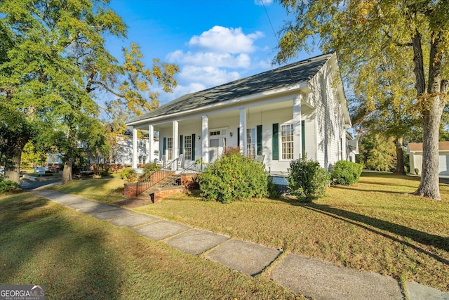 view of front facade featuring covered porch and a front yard