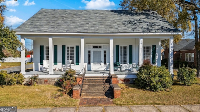 view of front of house with covered porch and a front yard