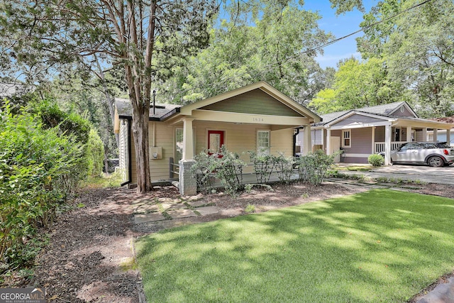 bungalow-style home featuring a front yard and a porch