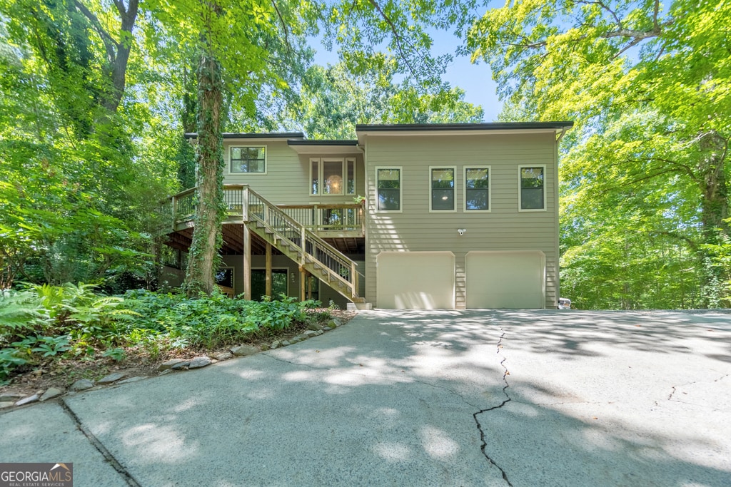 view of front of property featuring a garage and a wooden deck