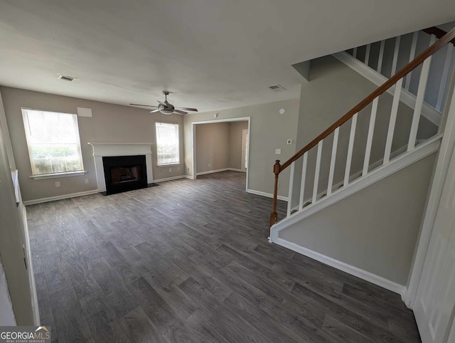 unfurnished living room featuring ceiling fan and hardwood / wood-style flooring