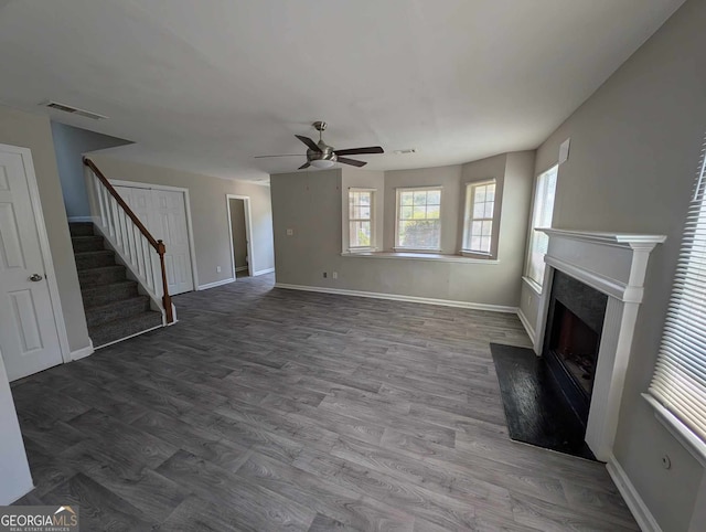 unfurnished living room featuring ceiling fan and hardwood / wood-style flooring