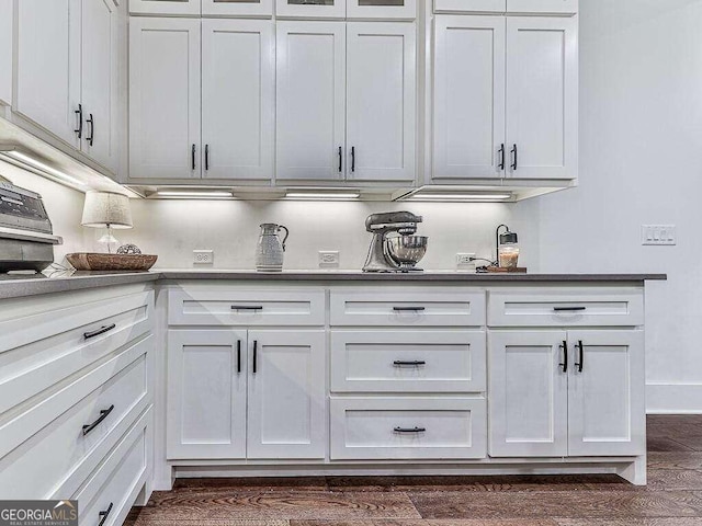 interior space with white cabinets and dark hardwood / wood-style flooring