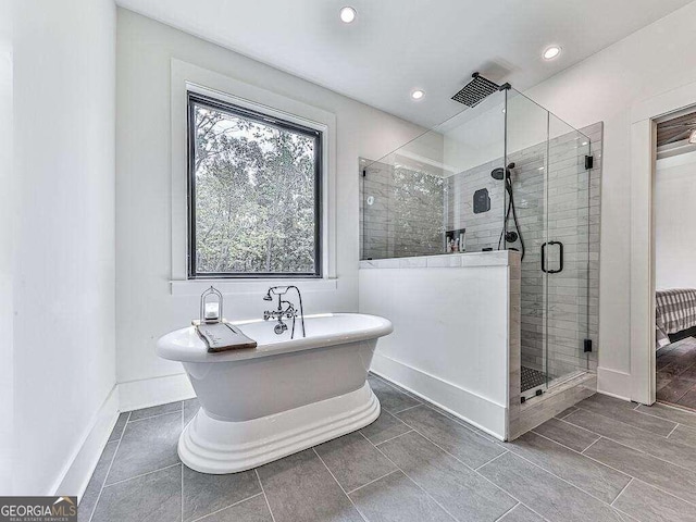 bathroom with tile patterned flooring and independent shower and bath