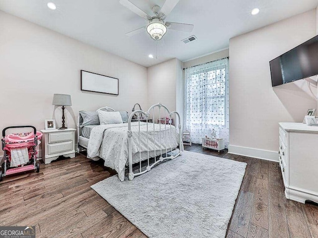 bedroom with dark hardwood / wood-style flooring and ceiling fan