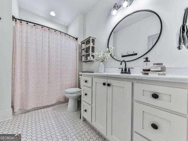 bathroom featuring vanity, toilet, and tile patterned flooring