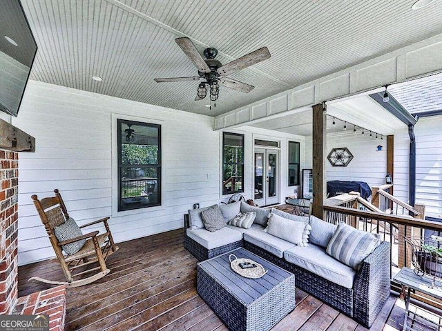 deck featuring ceiling fan, french doors, and an outdoor living space