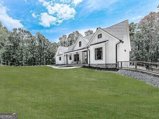 modern farmhouse style home with a front lawn