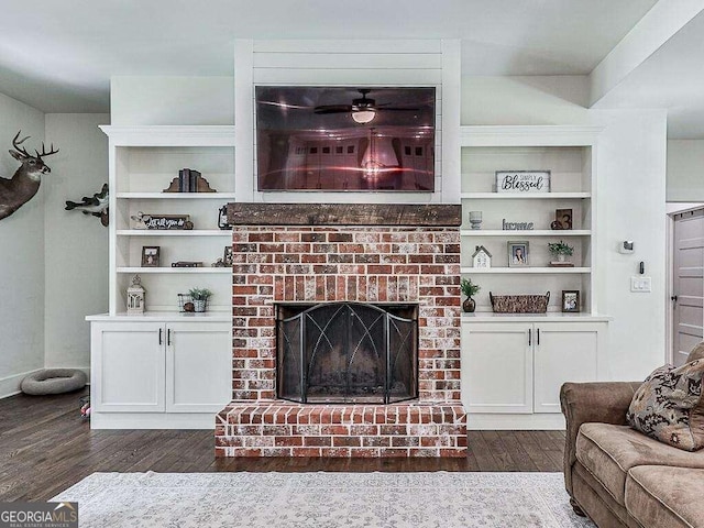 living room with dark wood-type flooring and a brick fireplace