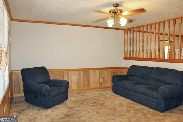 interior space with ceiling fan and crown molding