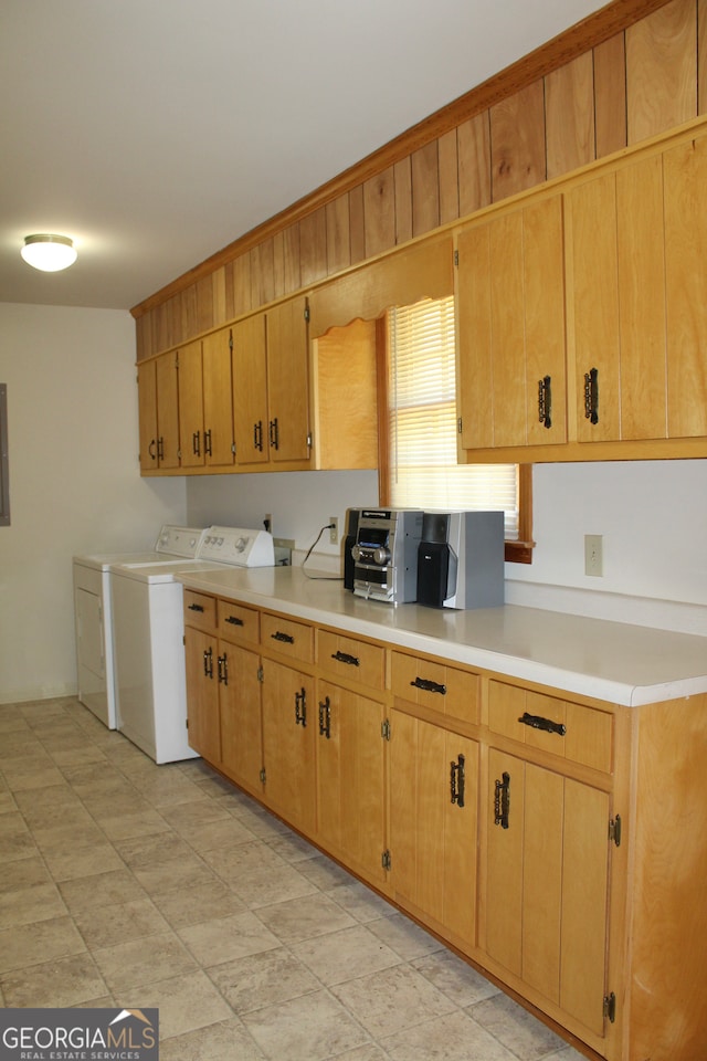 kitchen with light tile patterned floors, washing machine and clothes dryer, and electric panel