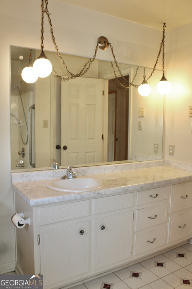 bathroom with tile patterned floors and vanity