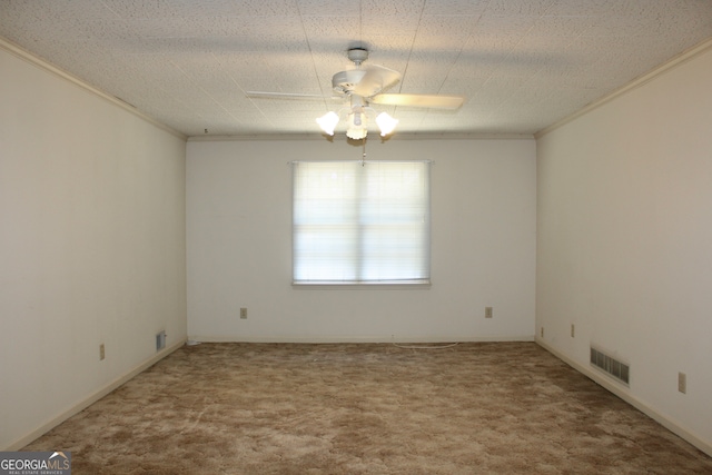 spare room featuring ceiling fan, carpet, crown molding, and a textured ceiling