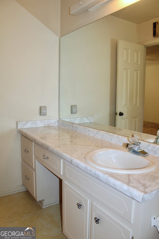 bathroom featuring tile patterned flooring and vanity