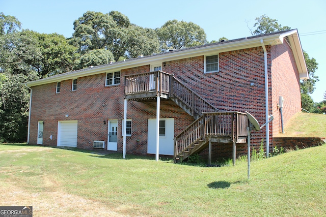 rear view of house featuring central air condition unit, a yard, and a wooden deck