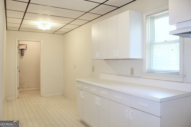 kitchen featuring white cabinets and light tile patterned flooring