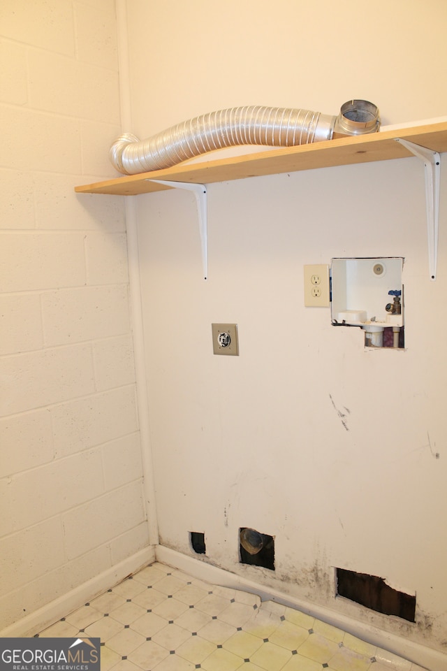 laundry room with electric dryer hookup and light tile patterned floors