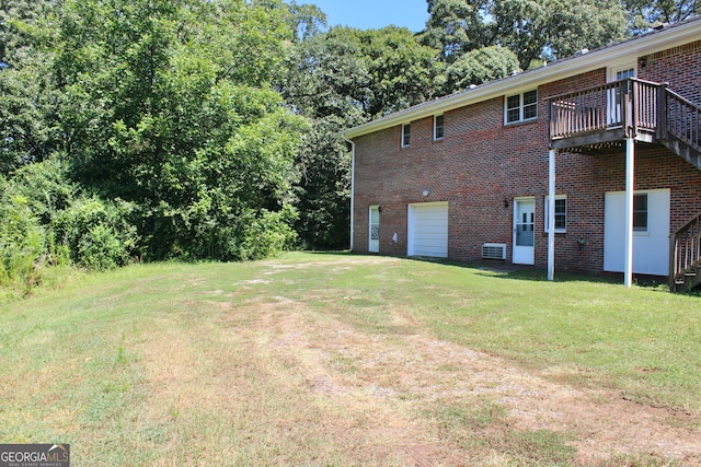 view of yard with a wooden deck and a garage