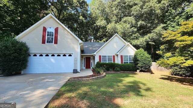 view of property featuring a front lawn and a garage