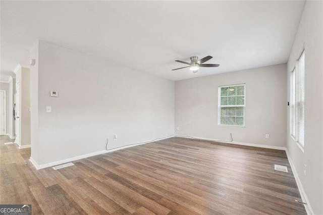 unfurnished room with ceiling fan and hardwood / wood-style floors