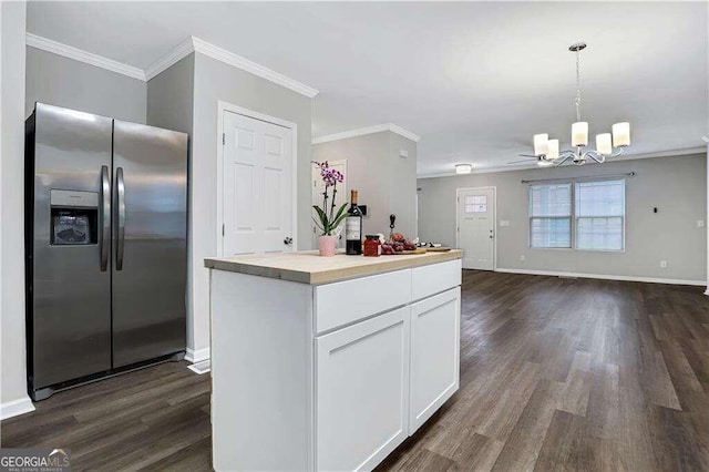 kitchen featuring white cabinets, pendant lighting, crown molding, and stainless steel fridge with ice dispenser