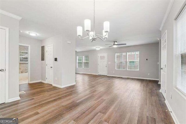 interior space featuring ceiling fan with notable chandelier, hardwood / wood-style flooring, and crown molding