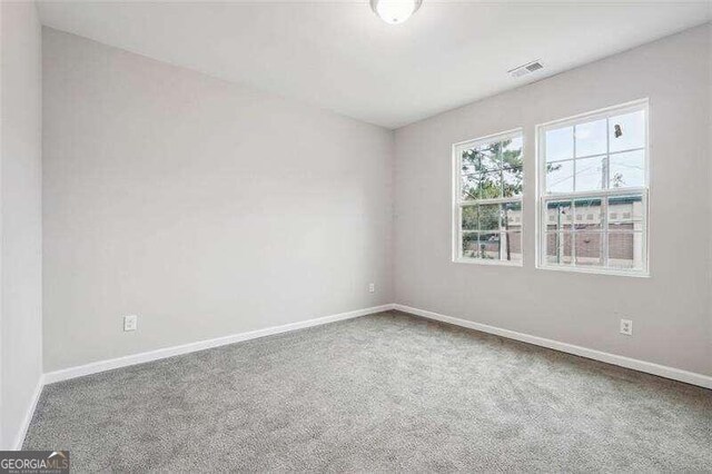 unfurnished room featuring carpet