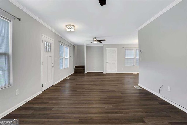 unfurnished living room featuring a healthy amount of sunlight, dark hardwood / wood-style flooring, ornamental molding, and ceiling fan