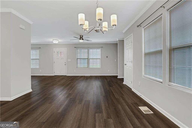 unfurnished dining area featuring ceiling fan with notable chandelier, dark hardwood / wood-style flooring, and ornamental molding