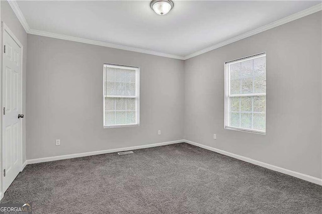 carpeted spare room with crown molding