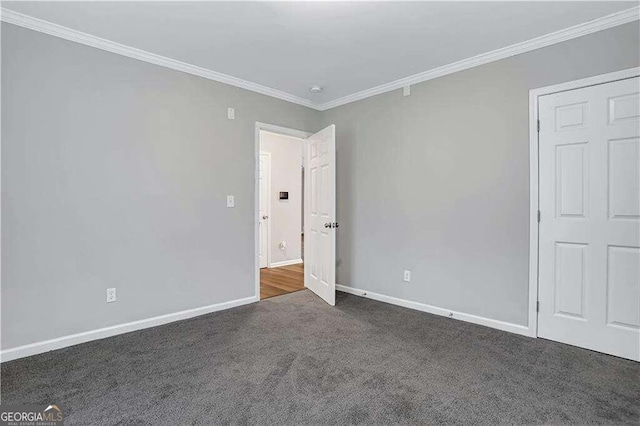 unfurnished bedroom featuring dark carpet and crown molding