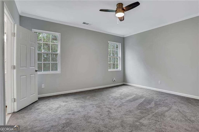 carpeted spare room featuring ornamental molding and ceiling fan