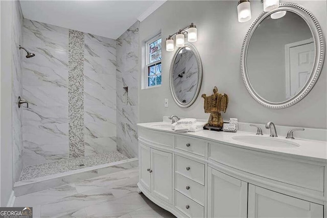 bathroom with dual vanity, a tile shower, tile patterned flooring, and crown molding