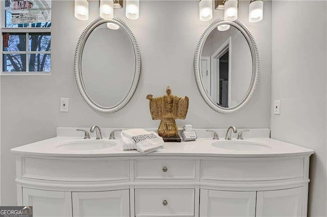 bathroom with a chandelier and vanity