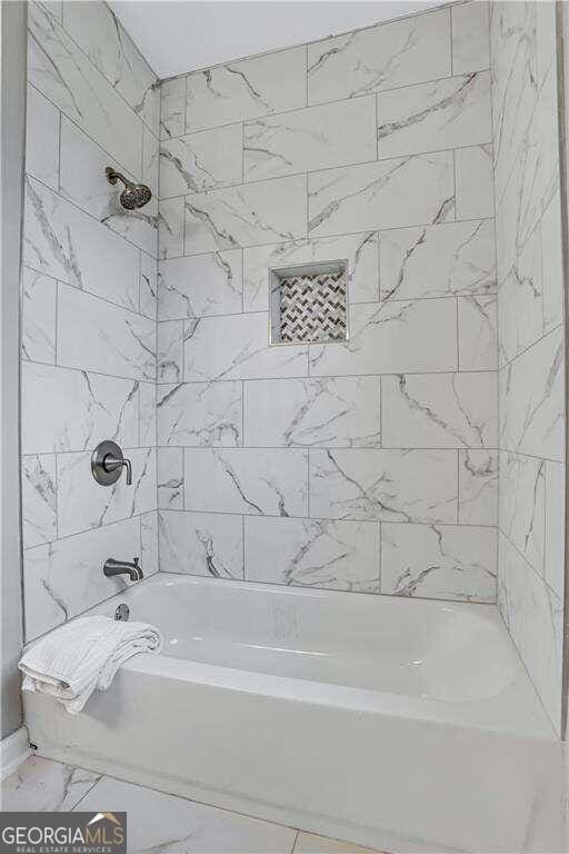 bathroom with tiled shower / bath combo