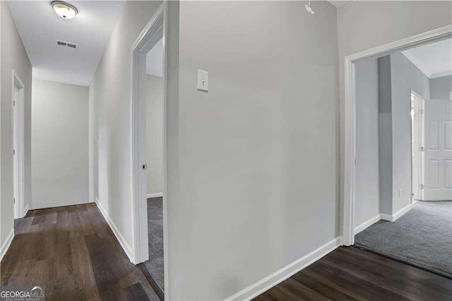 hallway with dark wood-type flooring