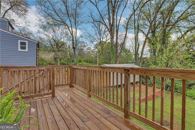 wooden deck featuring a lawn