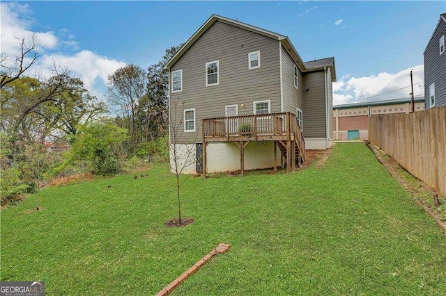 back of house with a lawn and a deck