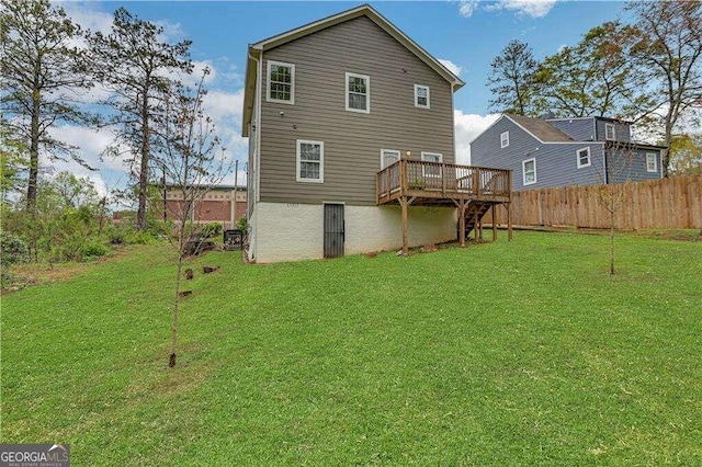 back of house with a yard and a deck