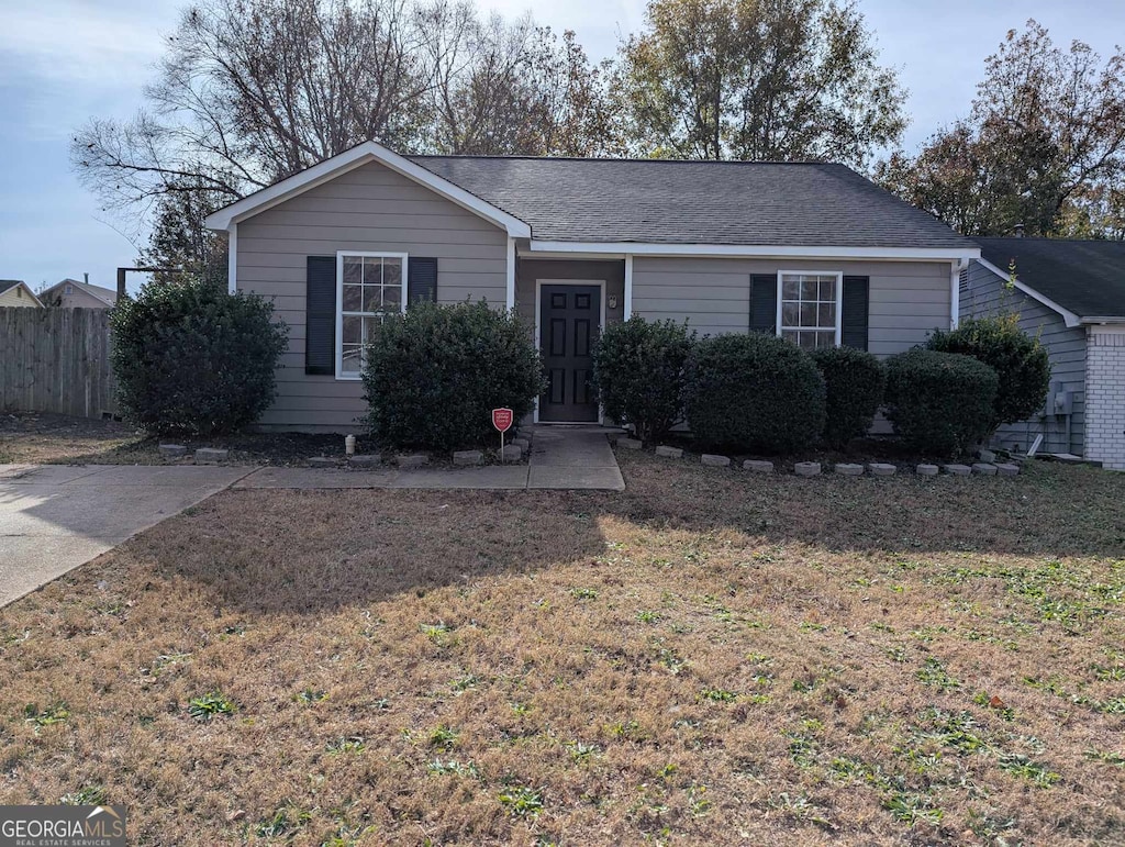 single story home featuring a front lawn