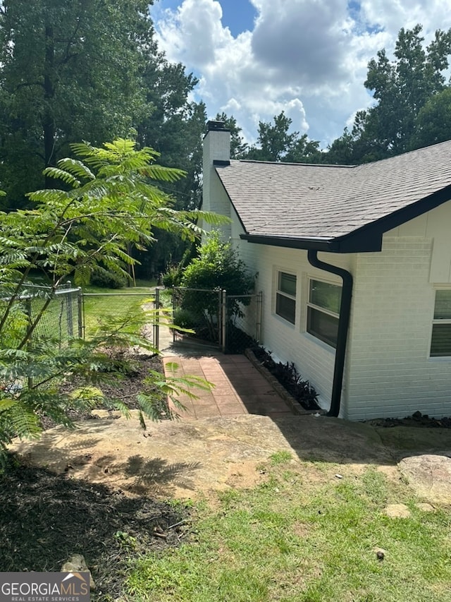 view of side of home with a yard