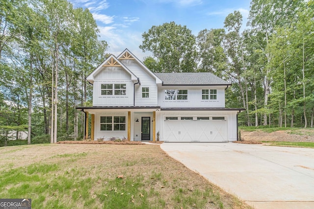 view of front of home with a garage and a front lawn