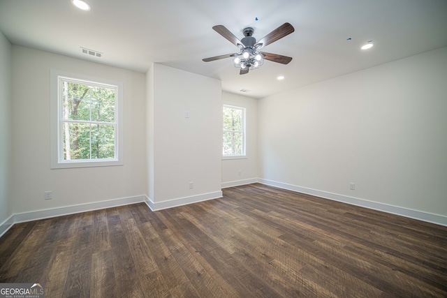 spare room featuring ceiling fan and dark wood-type flooring