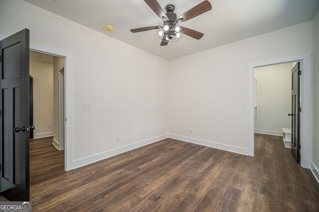 empty room featuring dark hardwood / wood-style floors and ceiling fan