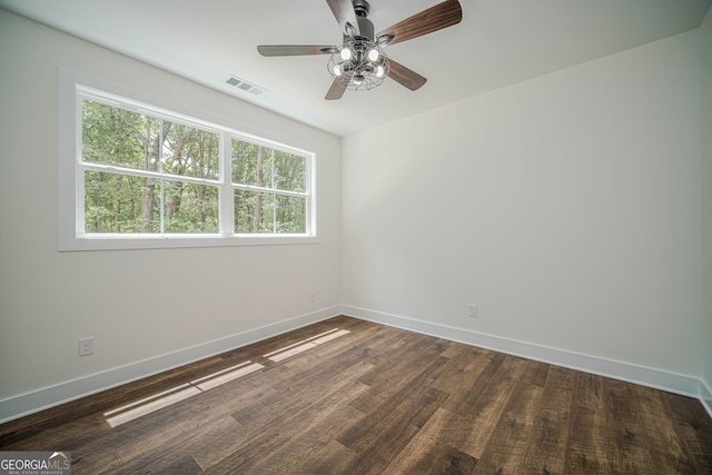 unfurnished room with ceiling fan and dark hardwood / wood-style flooring