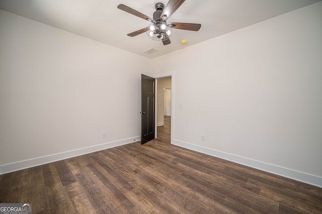 spare room with ceiling fan and dark hardwood / wood-style floors