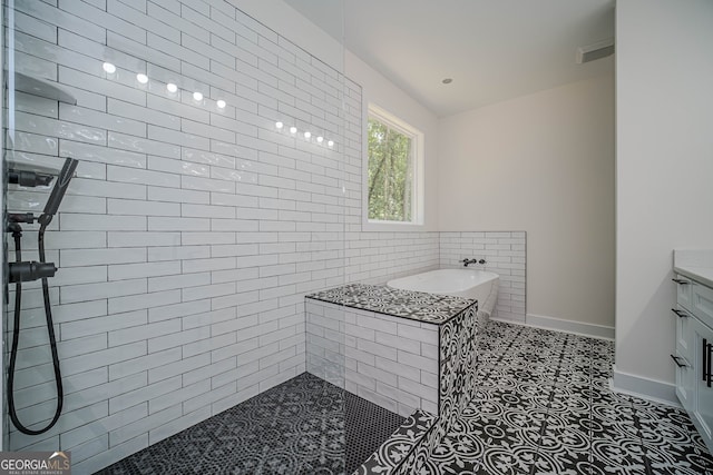 bathroom featuring a tub to relax in and vanity