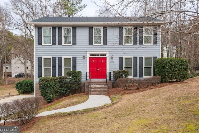 colonial inspired home with a front yard